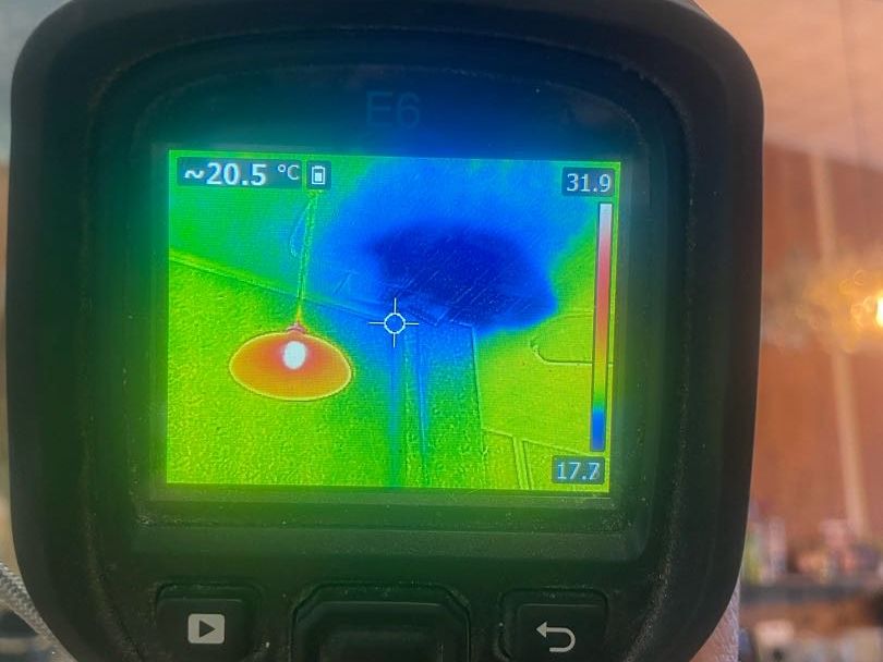 A thermal camera showing a cold patch spreading across the salon ceiling